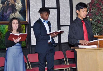 Angela Volpe, Elyjah (junior), and Mark (sophomore) sang the opening song.